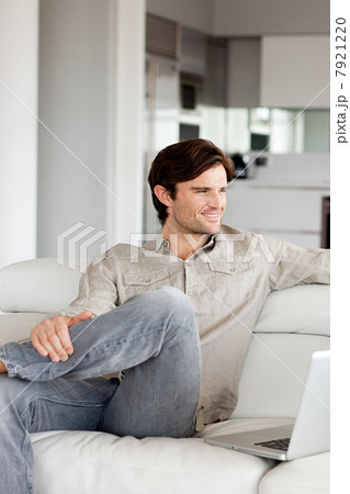 Man sitting on sofa, portrait Man sitting on sofa, portrait 7921220