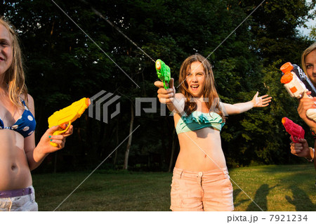 Girls having water fight with water pistols 7921234