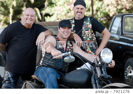 Men smiling around motorcycle Men smiling around motorcycle 7921276
