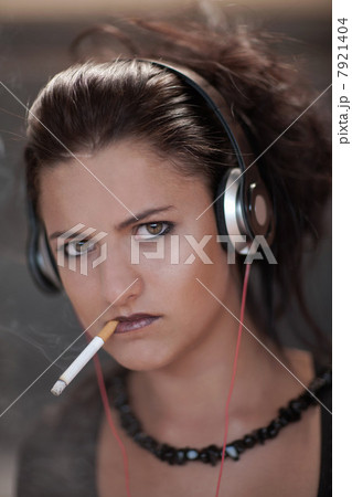 Teenage girl in dark makeup smoking Teenage girl in dark makeup smoking 7921404