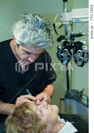 Doctor giving patient eye injection Doctor giving patient eye injection 7921668