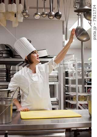 Female chef working in commercial kitchen 7921734