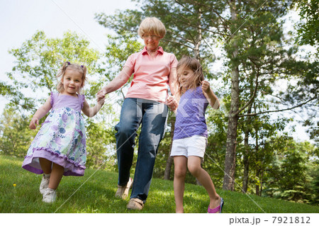 Grandmother and granddaughters holding hands 7921812