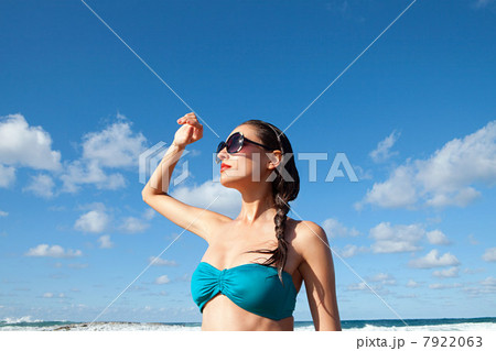 Woman on beach wearing sunglasses Woman on beach wearing sunglasses 7922063