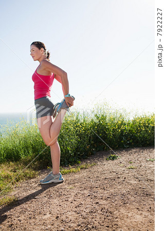 Young woman stretching leg Young woman stretching leg 7922227