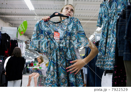 Teenage girl shopping for dress 7922529