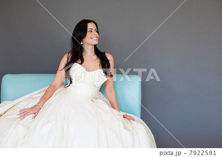 Young woman wearing white wedding dress, studio shot Young woman wearing white wedding dress, studio shot 7922591