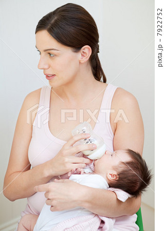Mother bottle feeding baby 7922752