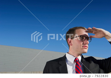 Businessman shielding eyes Businessman shielding eyes 7922830