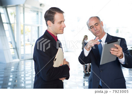 Two businessmen using digital tablet 7923005