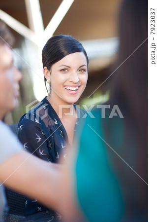 Smiling woman sitting at table outdoors Smiling woman sitting at table outdoors 7923037
