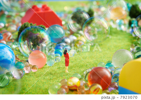 Figurines on pretend grass with marbles 7923070