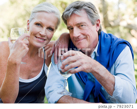 Mature couple outdoors with wine 7923071