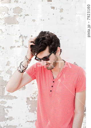 Young man scratching head 7923160