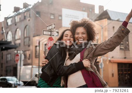 Women hugging on city street Women hugging on city street 7923261