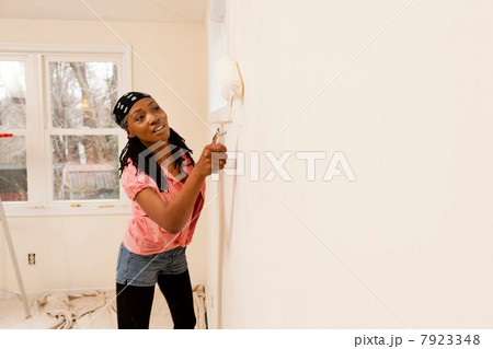 Woman painting in new home 7923348