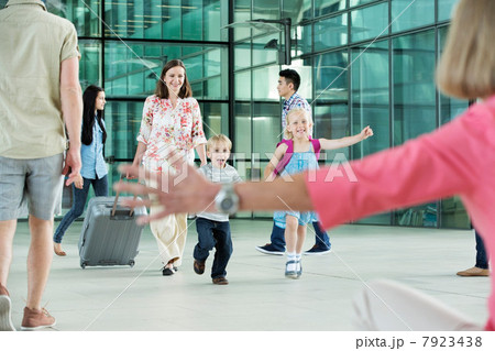 Children running excitedly towards grandmother Children running excitedly towards grandmother 7923438