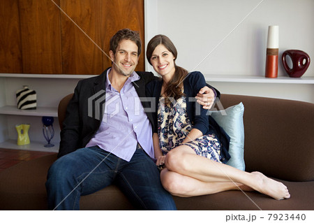 Couple sitting on sofa, portrait 7923440
