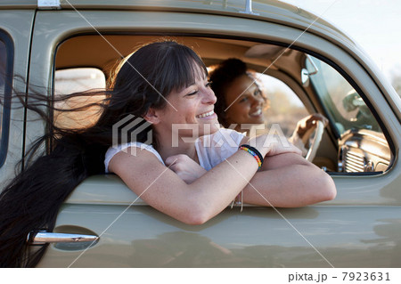 Young women travelling in car on road trip, smiling Young women travelling in car on road trip, smiling 7923631