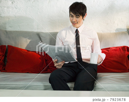 Young man in cafe reading newspaper Young man in cafe reading newspaper 7923678