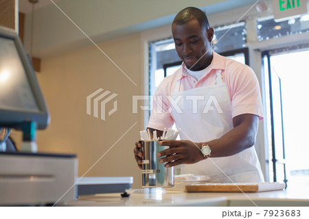 Cashier organizing spoons in store Cashier organizing spoons in store 7923683