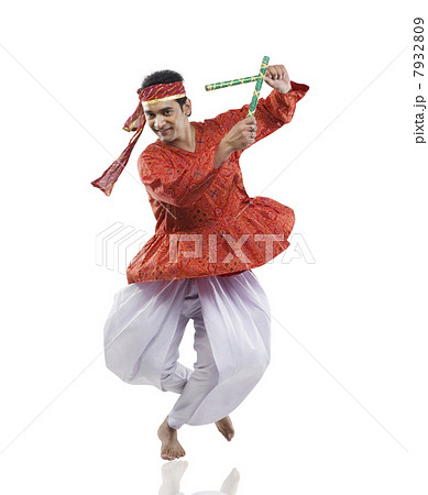 Gujarati man performing dandiya Gujarati man performing dandiya 7932809