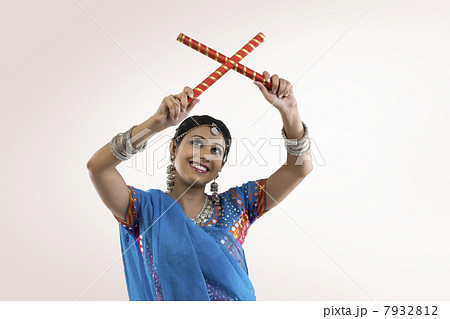 Gujarati woman with dandiya sticks 7932812