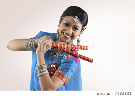 Gujarati woman performing dandiya Gujarati woman performing dandiya 7932831