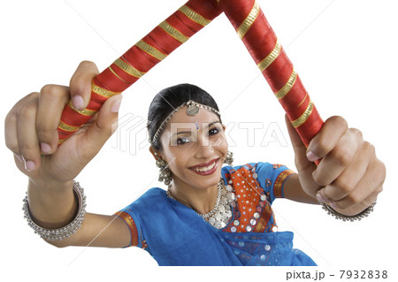 Gujarati woman performing dandiya Gujarati woman performing dandiya 7932838