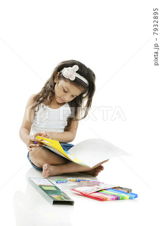 Girl looking at a colouring book 7932895