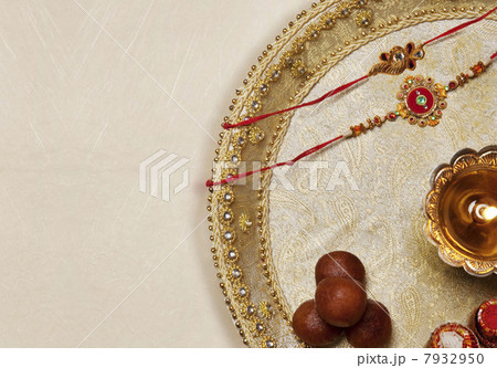 Rakhi , diya and sweets in a tray 7932950