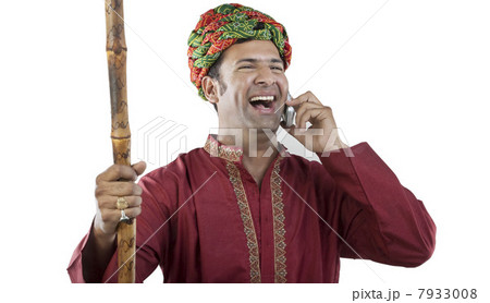 Gujarati man talking on a mobile phone Gujarati man talking on a mobile phone 7933008