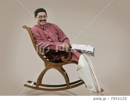 South Indian man sitting on a chair South Indian man sitting on a chair 7933120