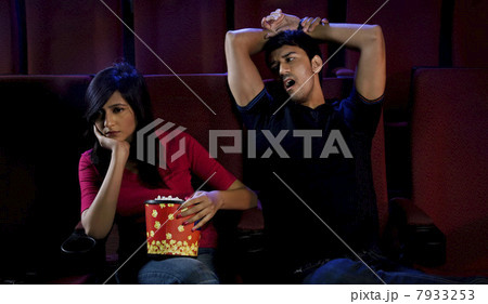 Couple getting bored watching a movie Couple getting bored watching a movie 7933253