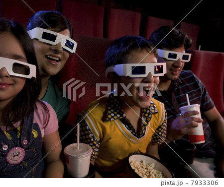 Family watching a movie with 3D glasses Family watching a movie with 3D glasses 7933306