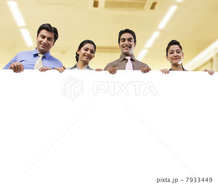Businesspeople holding a placard Businesspeople holding a placard 7933449