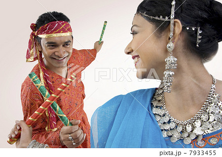 Gujarati couple performing dandiya Gujarati couple performing dandiya 7933455