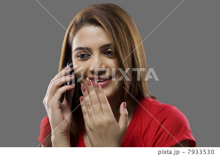 Woman talking on a mobile phone Woman talking on a mobile phone 7933530