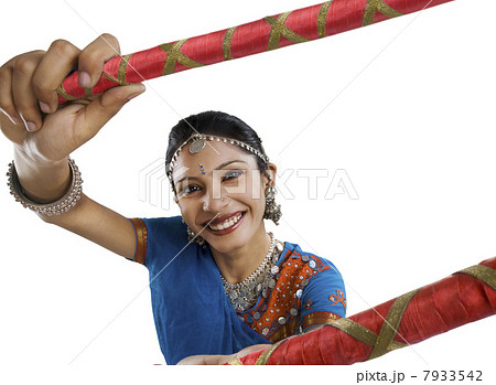 Gujarati woman performing dandiya Gujarati woman performing dandiya 7933542