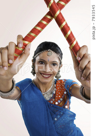 Gujarati woman performing dandiya Gujarati woman performing dandiya 7933545