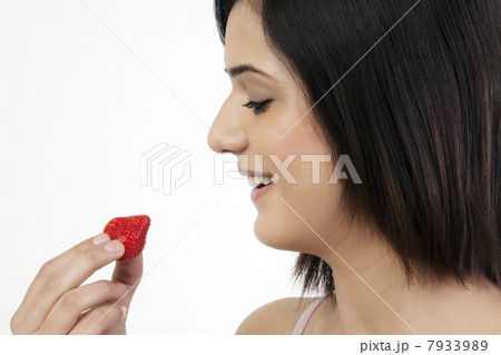 Woman holding a strawberry 7933989