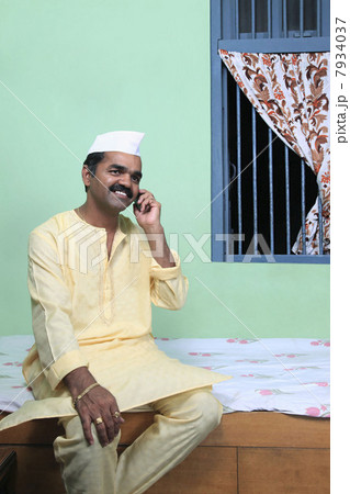 Maharashtrian man talking on a mobile phone 7934037