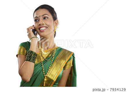 Woman talking on a mobile phone Woman talking on a mobile phone 7934129