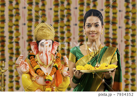 Portrait of a woman performing a pooja Portrait of a woman performing a pooja 7934352