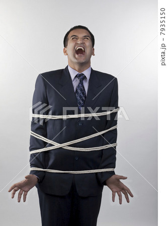 Businessman tied up with rope 7935150