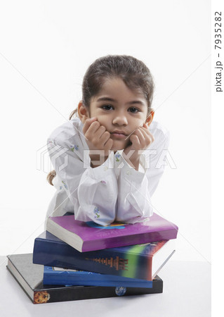 Girl leaning on a stack of books 7935282
