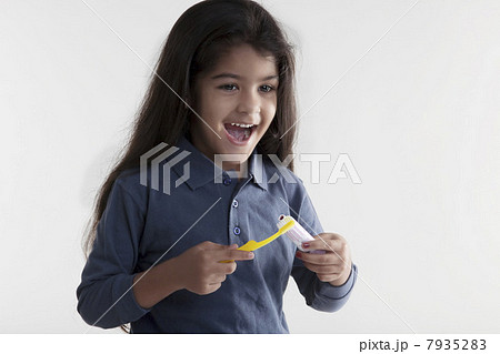 Girl with toothbrush and toothpaste Girl with toothbrush and toothpaste 7935283