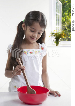 Girl with a spatula and a bowl Girl with a spatula and a bowl 7935285