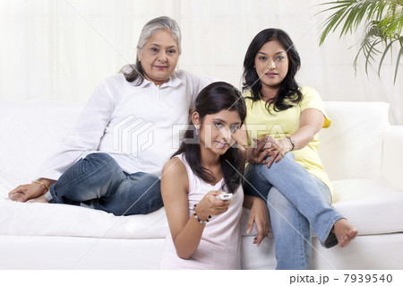 Women and girl watching television Women and girl watching television 7939540