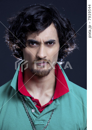 Portrait of angry young man grimacing 7939544